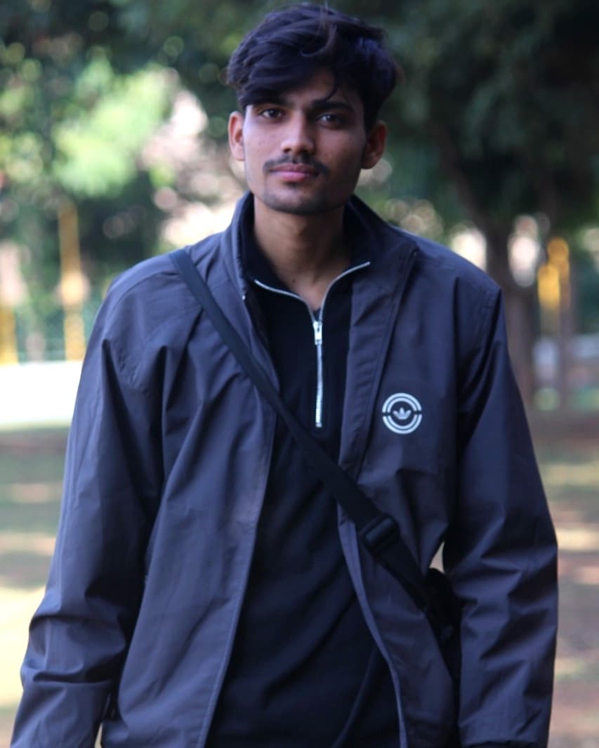 Awanish Mishra outdoors in a dark half-zip jacket